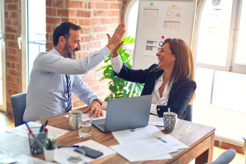 high five between tow business partners