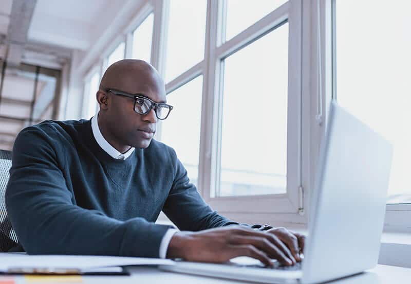 A man ordering something on a laptop