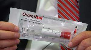 a person holding a sealed oral fluid test kit