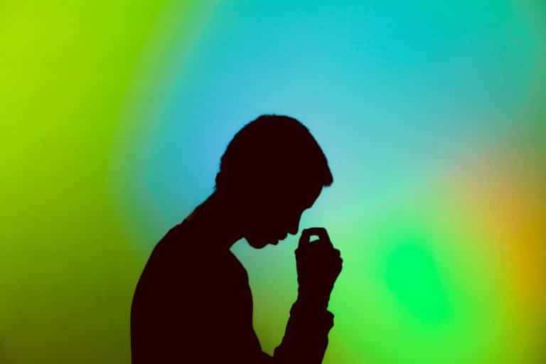 silhouette on a green, blue, and orange background