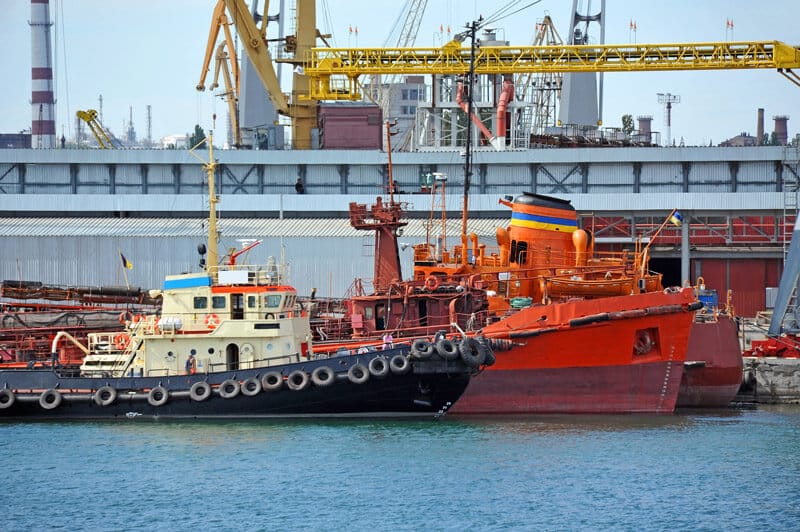 US Coast Guard in a boat harbor with other ships